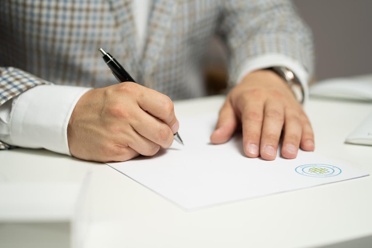 Family members reviewing and signing mortgage paperwork together
