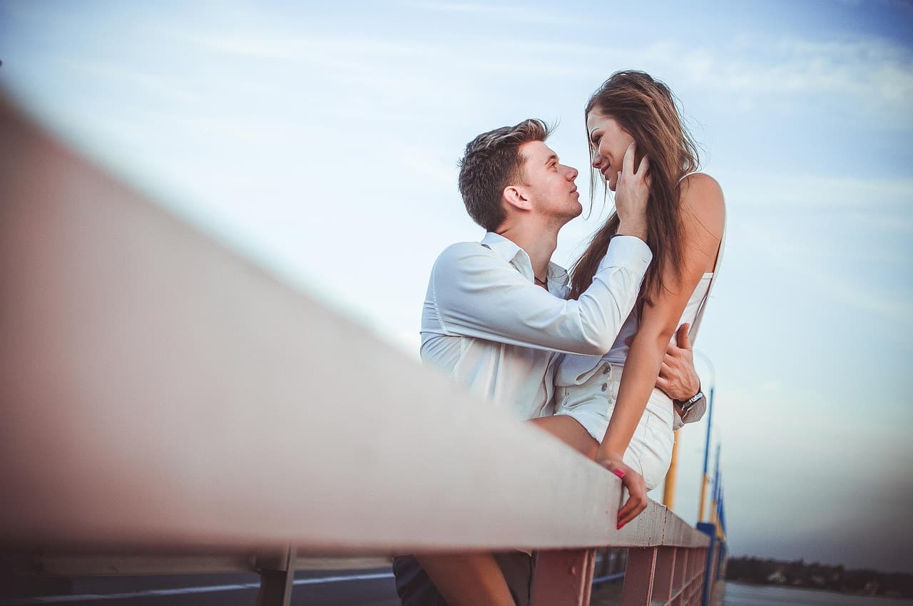 Young couple standing outside a home they are buying