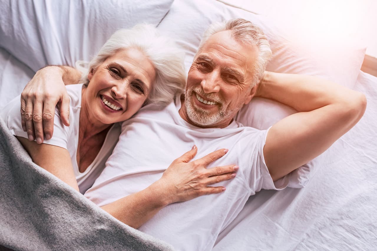 Older couple reading through lifetime mortgage terms at home